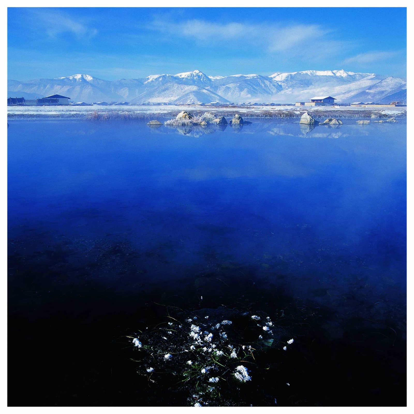 Crystal blue lake with mountain reflections